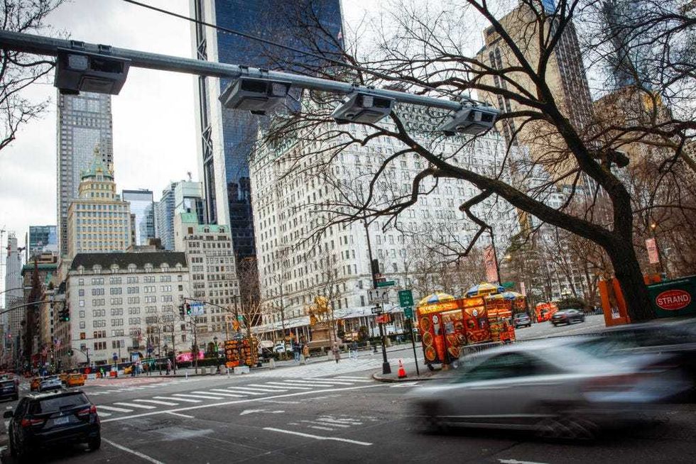 Cars pass under E-ZPass readers and license plate-scanning cameras on Fifth Avenue as congestion pricing takes effect in New York City on Jan. 5, 2024.