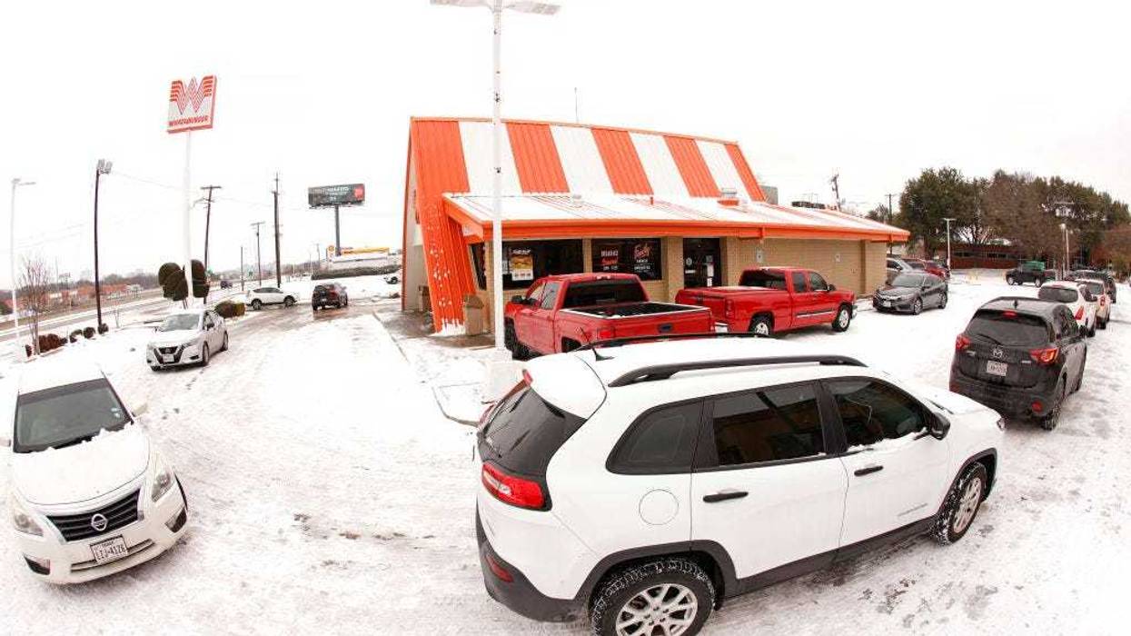 Cars wrap around a Whataburger franchise as they line up to order food after a snow storm on February 17, 2021 in Fort Worth, Texas.