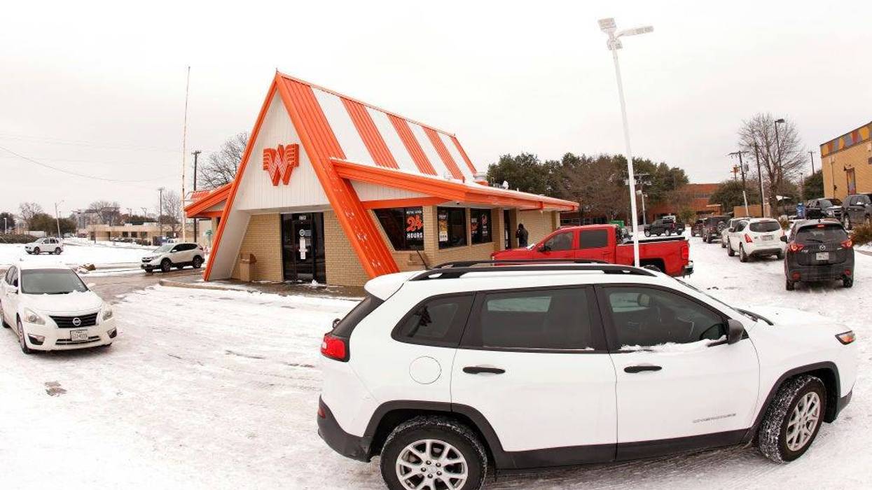 Cars wrap around a Whataburger franchise as they line up to order food after a snow storm on February 17, 2021 in Fort Worth,