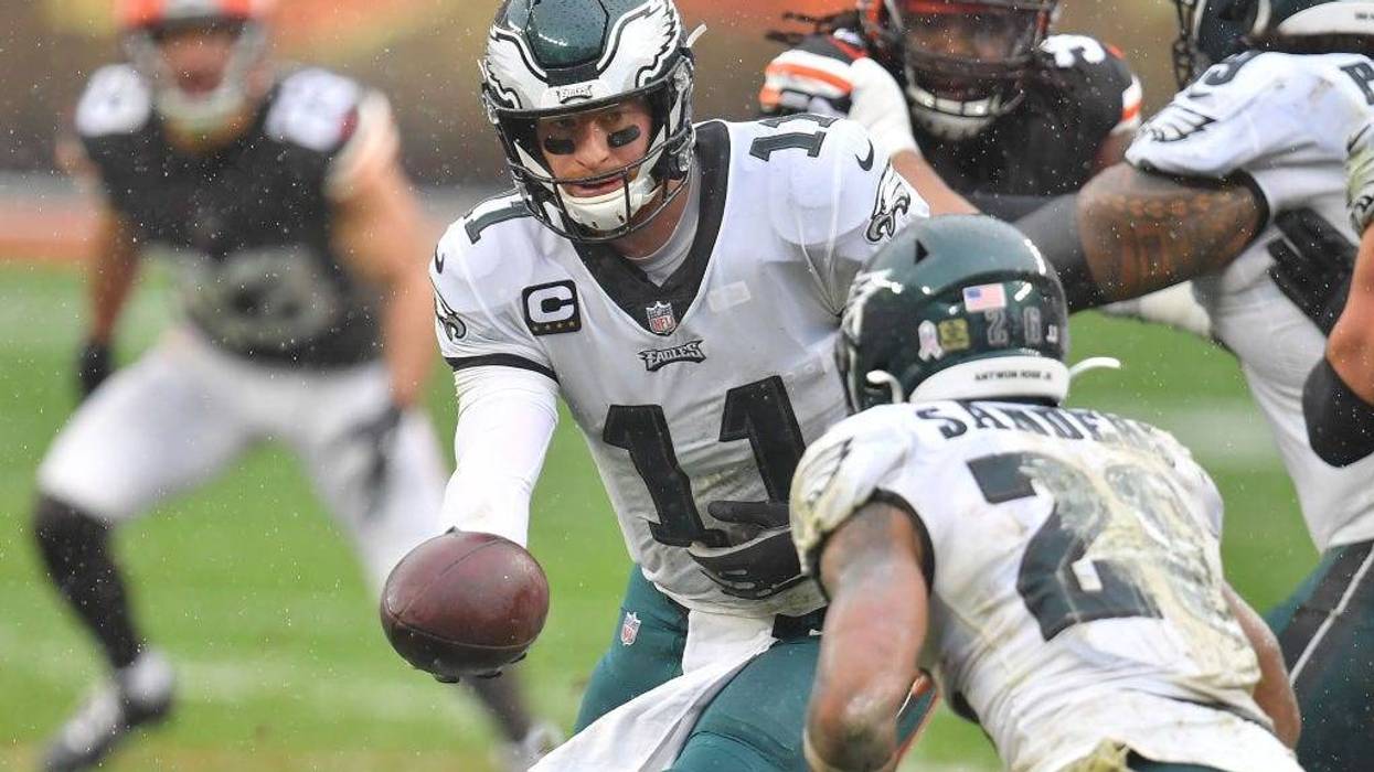 Carson Wentz #11 of the Philadelphia Eagles hands the ball to Miles Sander