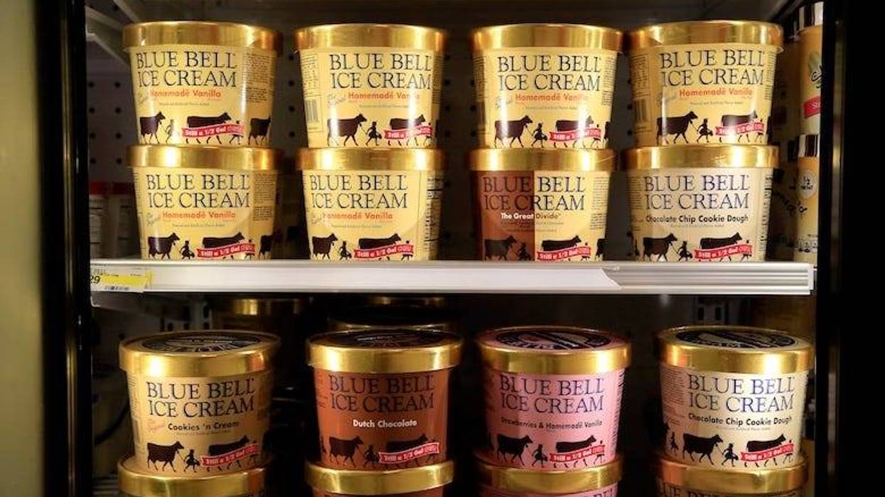 Cartons of Blue Bell ice cream in a grocery store freezer