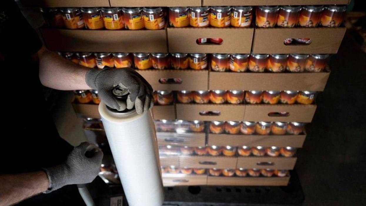 Cases of beer are wrapped in plastic for transport.