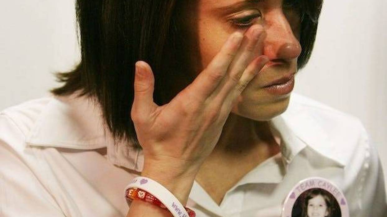 Casey Anthony, mother of missing 3-year-old Caylee Marie Anthony copes with tears as her attorney Jose Baez conducts a news conference
