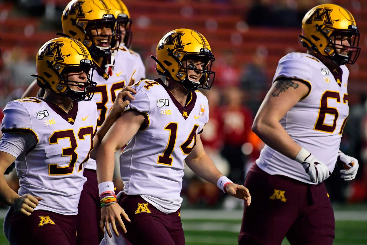 Casey O'Brien #14 of the Minnesota Golden Gophers, a four-time cancer survivor, is lauded for his efforts as holder during the fourth quarter at SHI Stadium on October 19, 2019 in Piscataway, New Jersey.