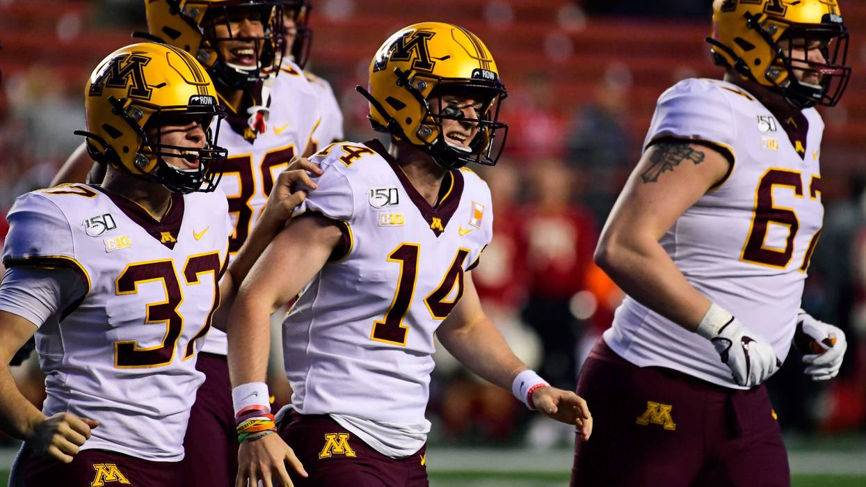 Casey O'Brien #14 of the Minnesota Golden Gophers, a four-time cancer survivor, is lauded for his efforts as holder during the fourth quarter at SHI Stadium on October 19, 2019 in Piscataway, New Jersey.