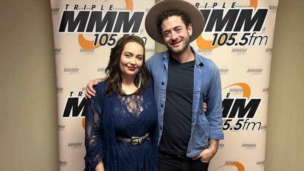 Cassandra Lewis and Trevor Bahnson in Studio M in front of banner