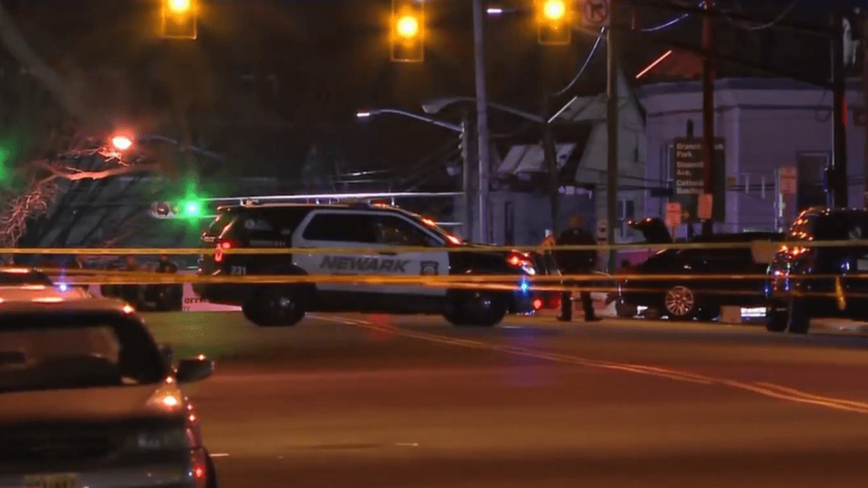 Caution tape and police cars at scene of shooting that left one officer dead and another injured on March 7, 2025 in Newark, New Jersey.