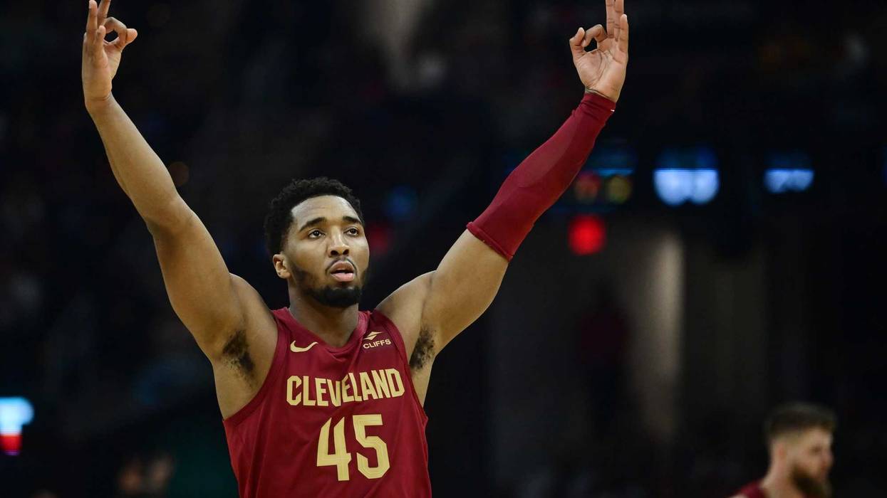 Cavaliers guard Donovan Mitchell (45) celebrates after forward Dean Wade (32) hit a three point basket during the first half against the Atlanta Hawks