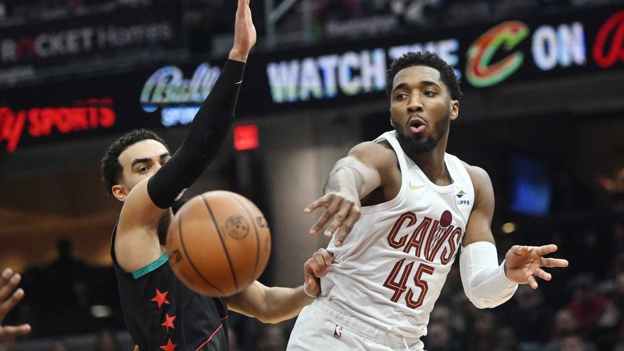 Cavaliers guard Donovan Mitchell (45) passes against Washington Wizards guard Tyus Jones (5) during the first half at Rocket Mortgage FieldHouse