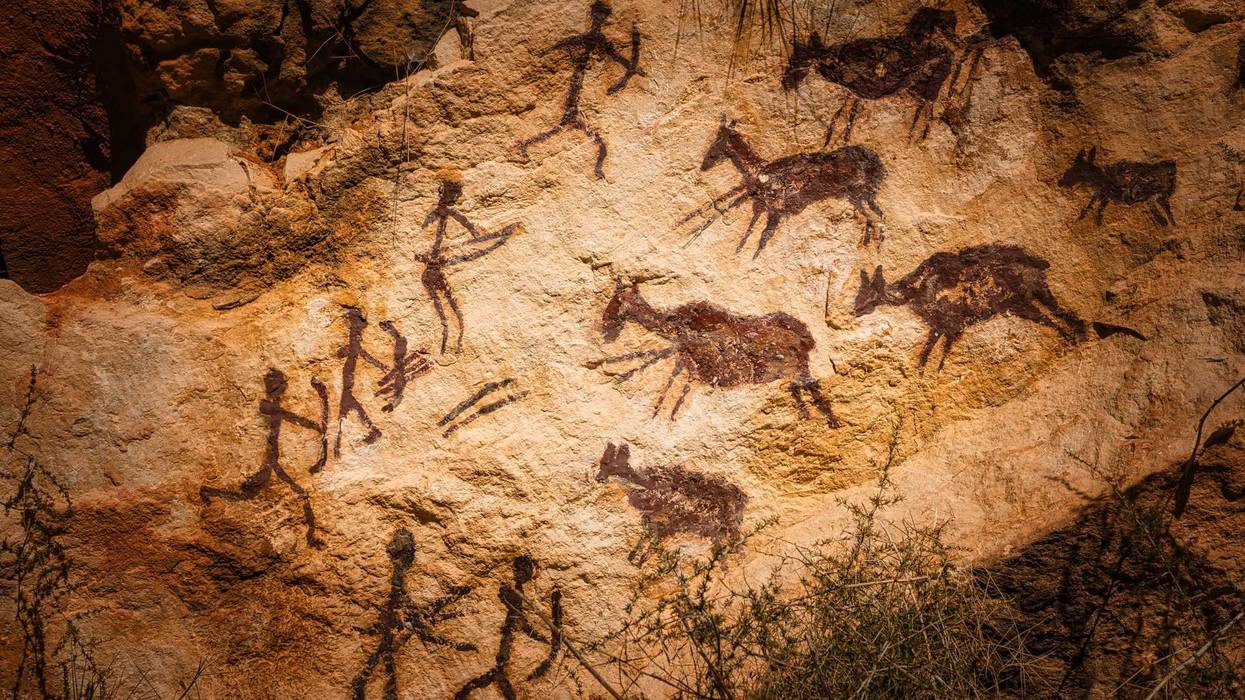 Cave art depicting early human species.