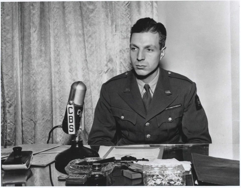 CBS News correspondent Richard C. Hottelet seated at a microphone and dressed in a U.S. war correspondent uniform in 1944