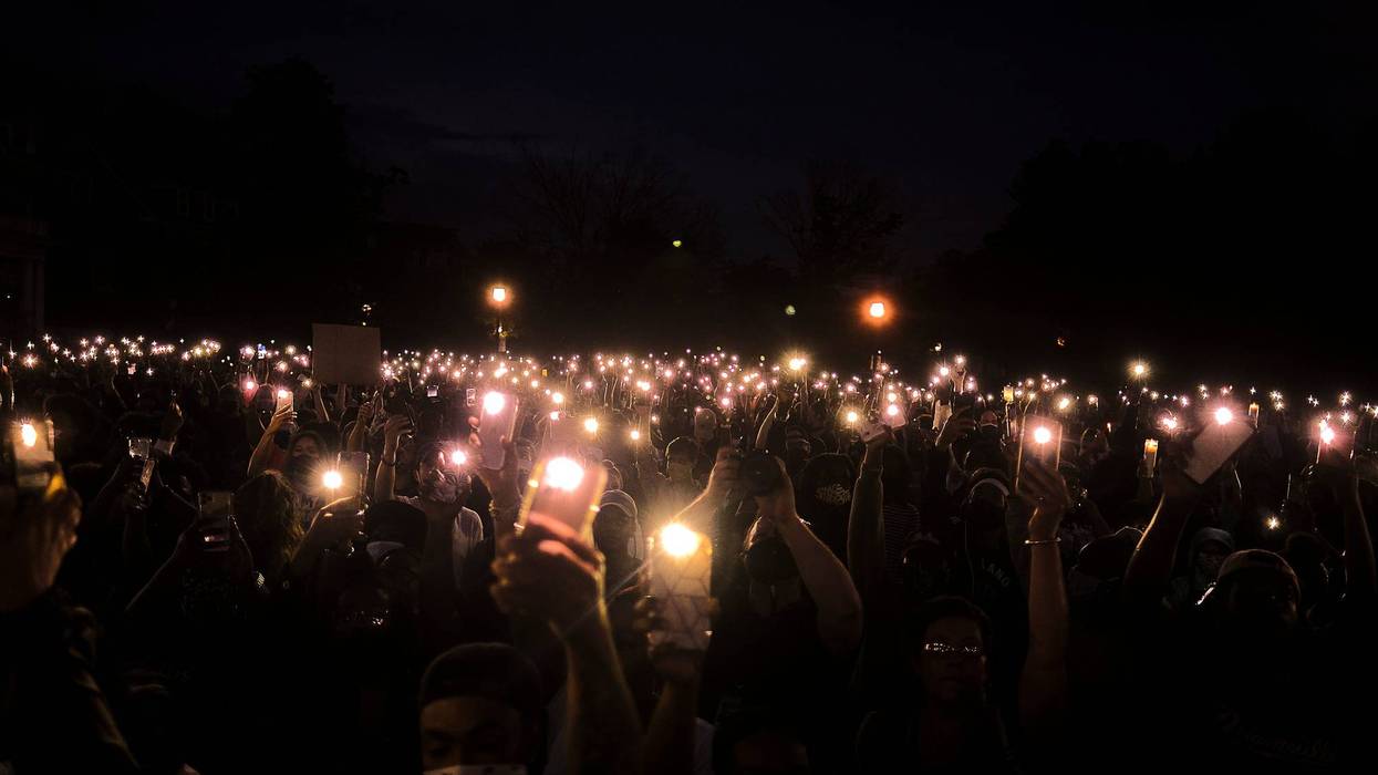 Cell phone lights during a moment of silence on Juneteenth.