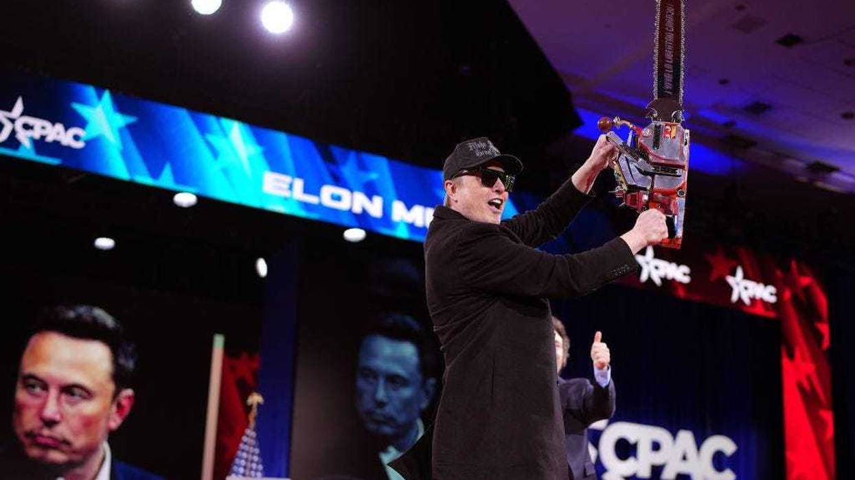 CEO of Tesla and SpaceX Elon Musk holds a chainsaw as he arrives on stage at the Conservative Political Action Conference (CPAC) at the Gaylord National Resort Hotel And Convention Center on February 20, 2025 in Oxon Hill, Maryland.