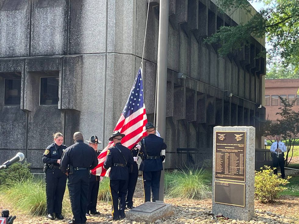Ceremonial raising of the flag to half mast at the Greenville County Sheriff