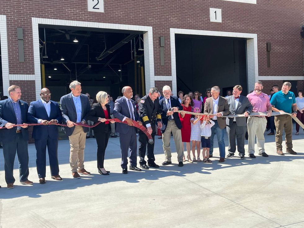 Ceremonial uncoupling of the hose to celebrate the new fire department headquarters grand opening