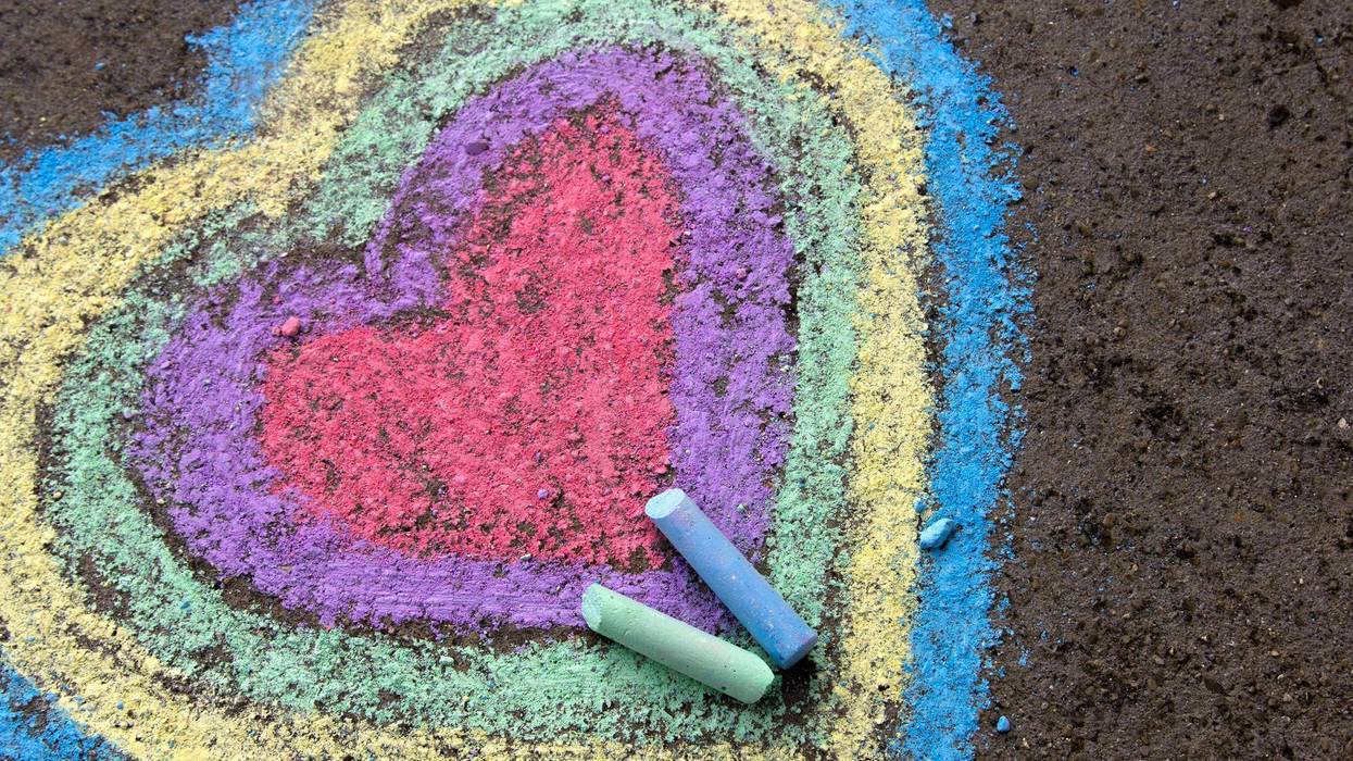 Chalk drawing: colorful hearts on asphalt