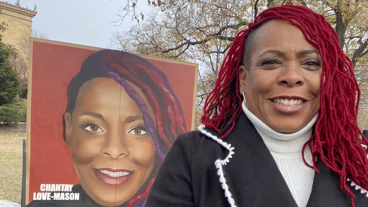 Chantay Love stands in front of the mural bearing her likeness outside the Philadelphia Museum of Art.