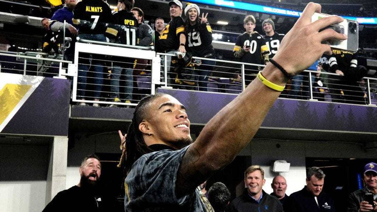 Chase Claypool #11 of the Pittsburgh Steelers takes photos with fans before the game