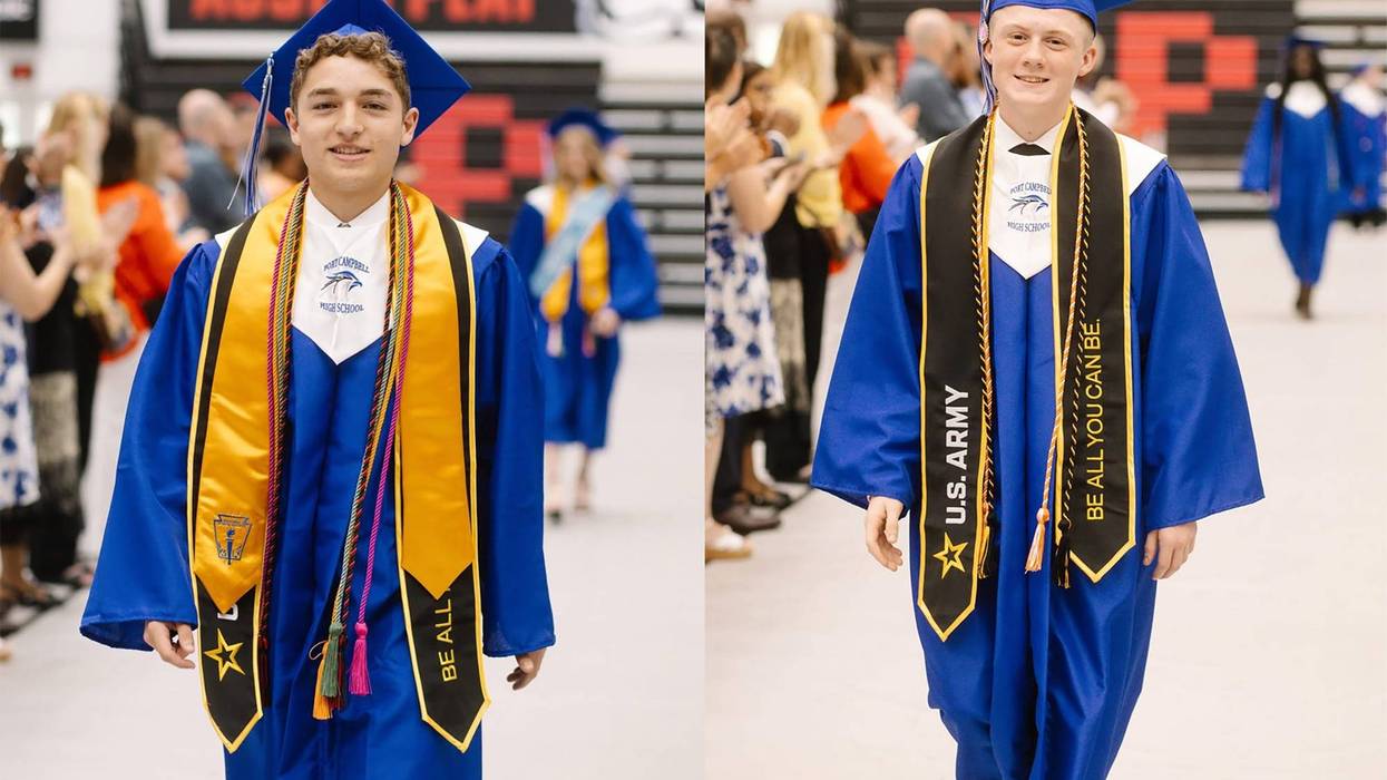 Chase Cribbett, left, and Christopher Johnson II, walk down an aisle at their graduation from Fort Campbell High School in Kentucky, May 16, 2025. Both students enlisted in the Army, following in their fathers' footsteps.