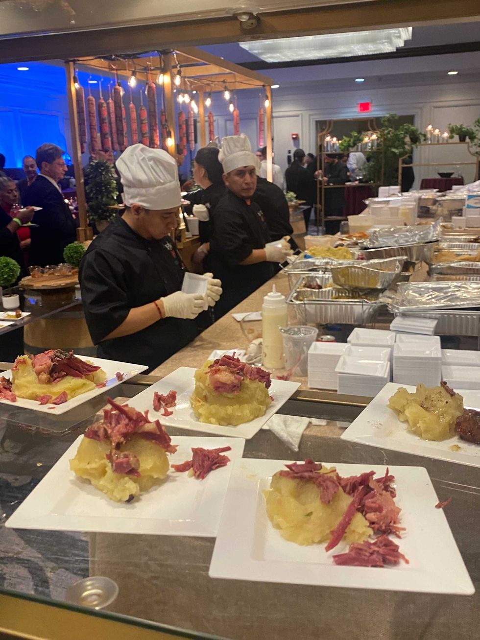 Chefs prepare various fare, including mashed potato-and-pastrami hors d