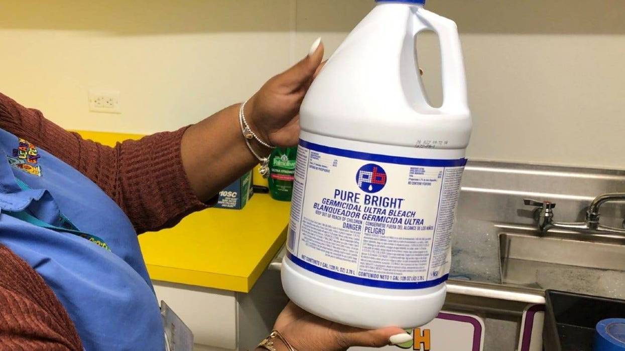 Cherrelle Shaw, director of a Center City preschool, holds a bottle of germicidal bleach.