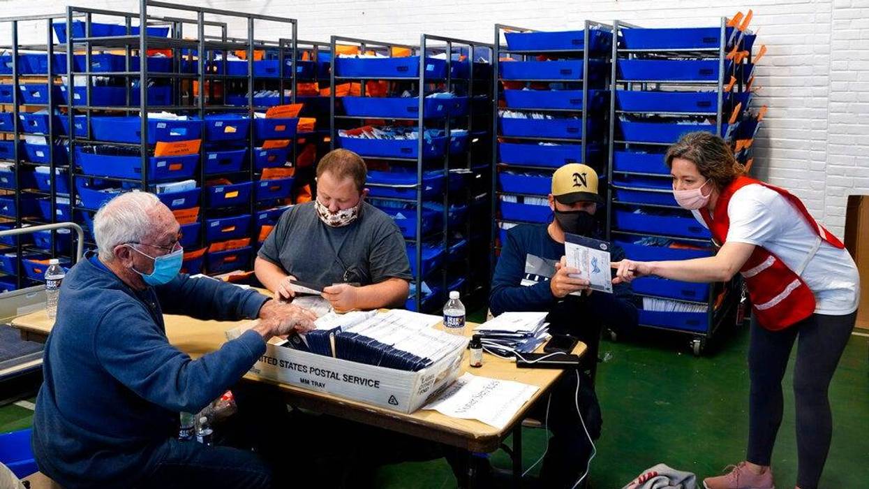 Chester County, Pa. election workers process mail-in and absentee ballots for the 2020 general election in the United States at West Chester University, Wednesday, Nov. 4, 2020, in West Chester, Pa.