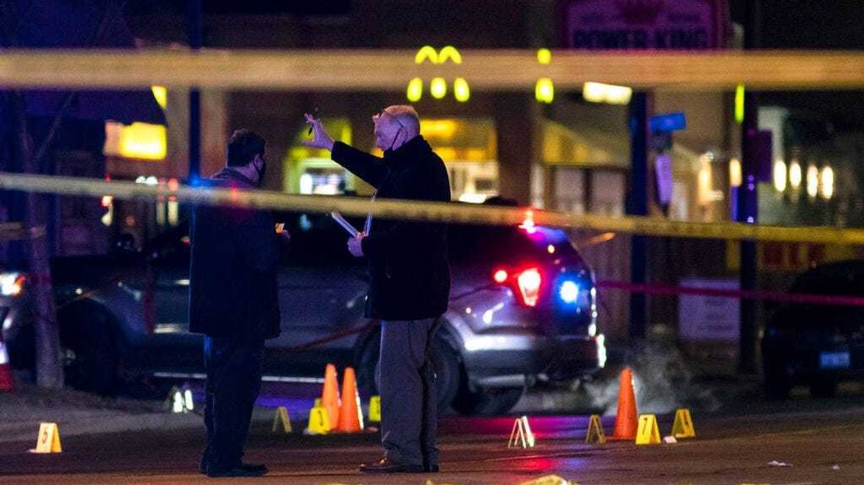 Chicago and Evanston police investigate a crime scene after a gunman went on a shooting spree before being killed by police during a shootout in Evanston, Ill., Saturday night, Jan. 9, 2021.