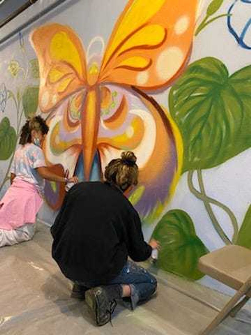Chicago artists are at the border painting a mural inside one of the shelters housing asylum seeking kids.