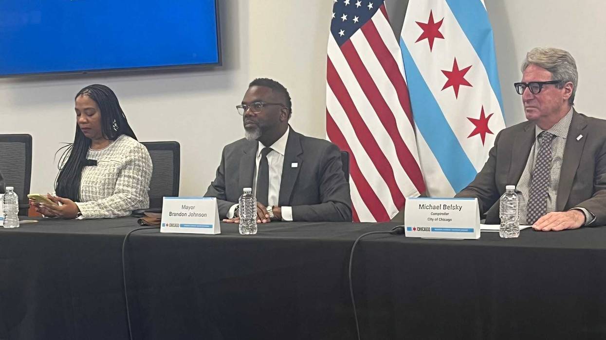 Chicago budget director Annette Guzman (left), Mayor Brandon Johnson, and comptroller Michael Belsky speak to reporters at City Hall.