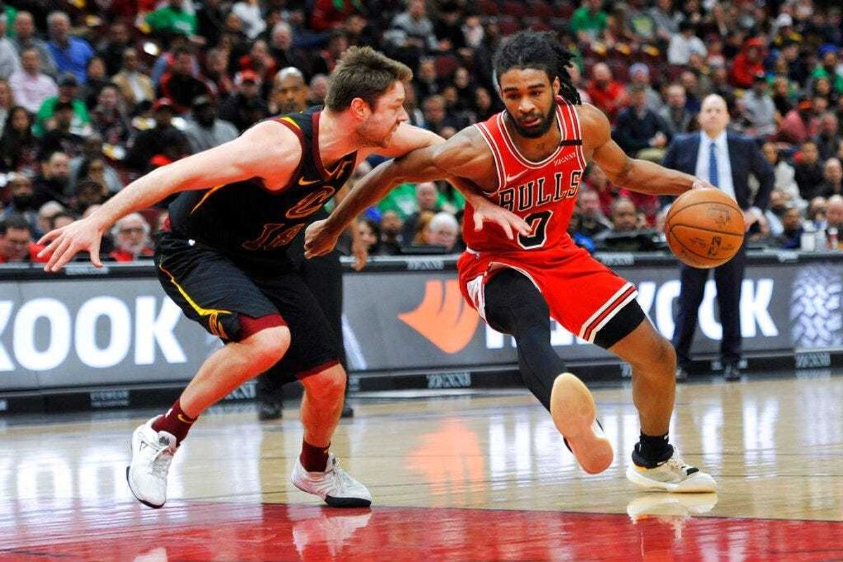 Chicago Bulls' Coby White (0) drives against Cleveland Cavaliers' Cedi Osman (16) during the second half of an NBA basketball game Tuesday, March 10, 2020, in Chicago. (AP Photo/Paul Beaty)