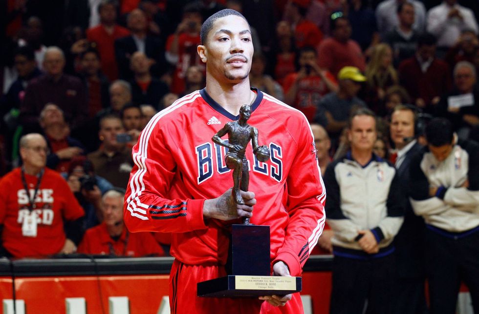Chicago Bulls point guard Derrick Rose (1) is presented the MVP trophy before game one of the second round of the 2011 NBA playoffs against the Atlanta Hawks at the United Center.