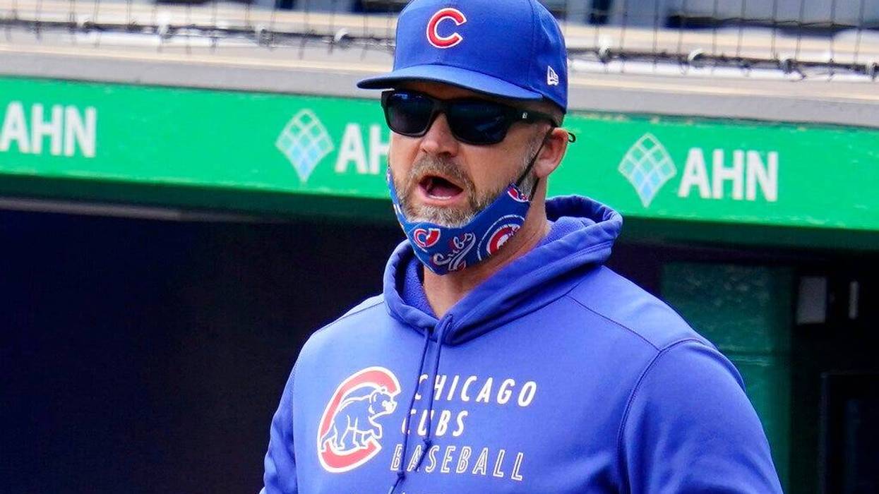 Chicago Cubs manager David Ross stands in the dugout during a baseball game against the Pittsburgh Pirates in Pittsburgh, Sunday, April 11, 2021.