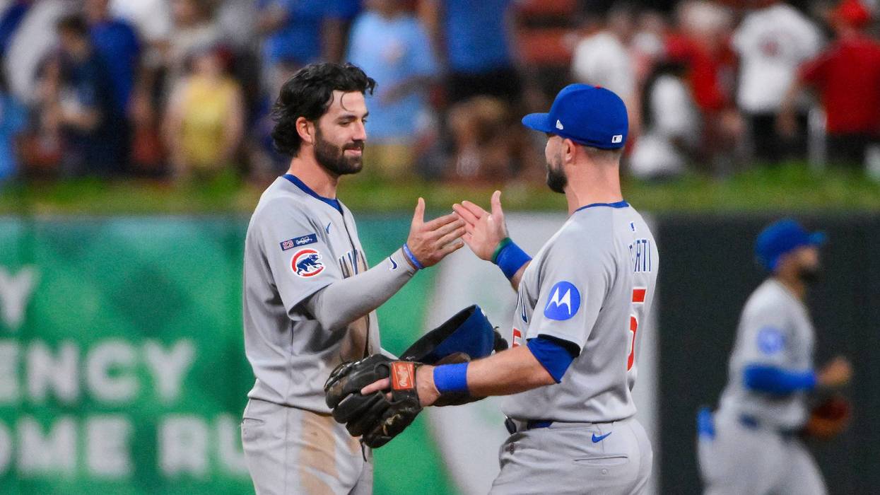 Chicago Cubs shortstop Dansby Swanson (7) celebrates with second baseman Jon Berti (5) after the Cubs defeated the St. Louis Cardinals at Busch Stadium.