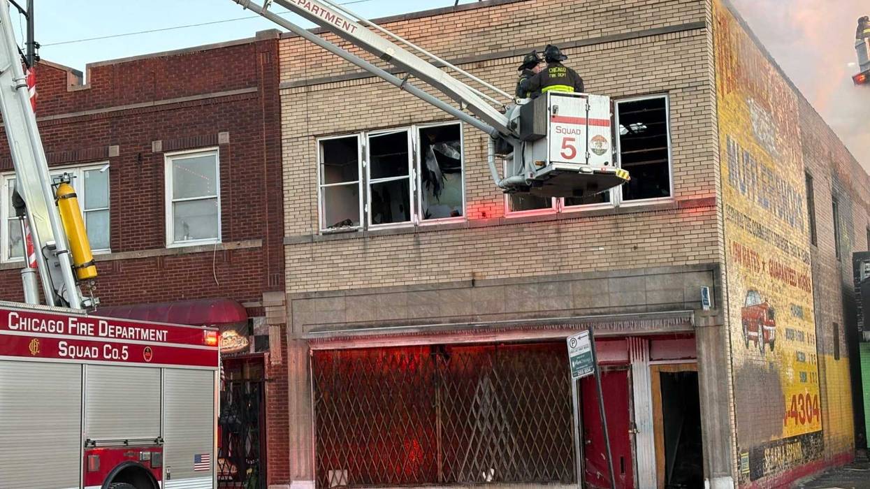 Chicago Firefighters on truck lift at SW Side fire