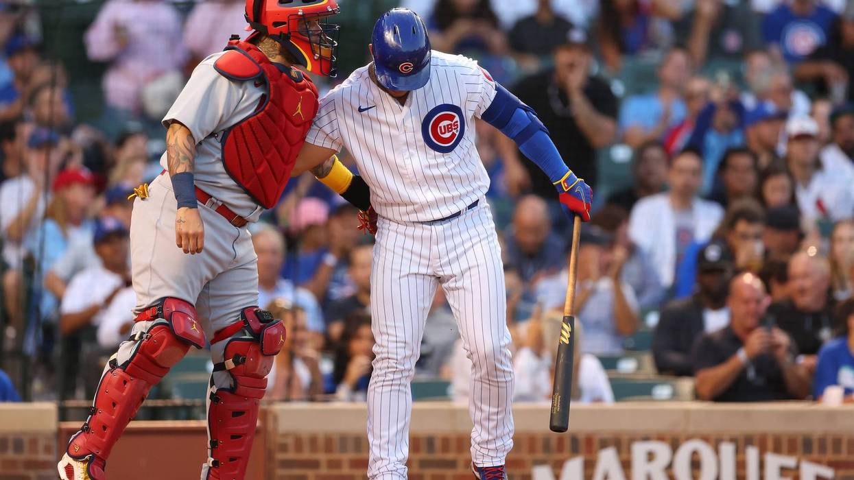 CHICAGO, ILLINOIS - AUGUST 22: Willson Contreras #40 of the Chicago Cubs greets Yadier Molina #4 of the St. Louis Cardinals during the first inning at Wrigley Field on August 22, 2022 in Chicago, Illinois.