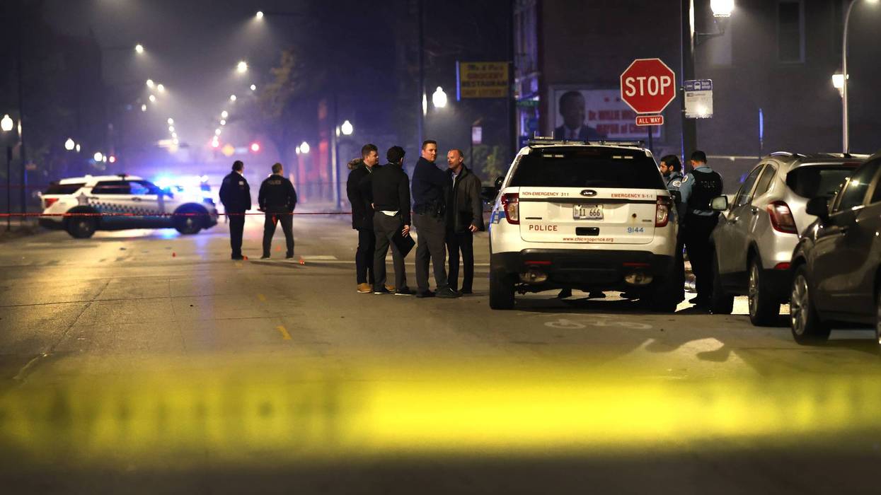 CHICAGO, ILLINOIS - OCTOBER 31: Police investigate the scene where as many as 14 people were reported to have been shot on October 31, 2022 in Chicago, Illinois. Three juveniles were among those reported to have been wounded in the drive-by shooting, according to published reports.