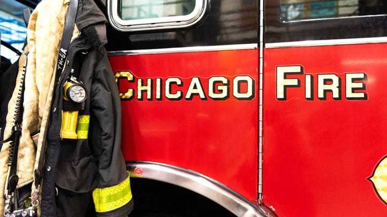 CHICAGO, ILLINOIS, USA - OCTOBER 10, 2018: The fireman's clothes by the real squad fire truck in Chicago Fire Department at the quarters of Engine Co. 5. The legendary series 'Chicago Fire' reportage