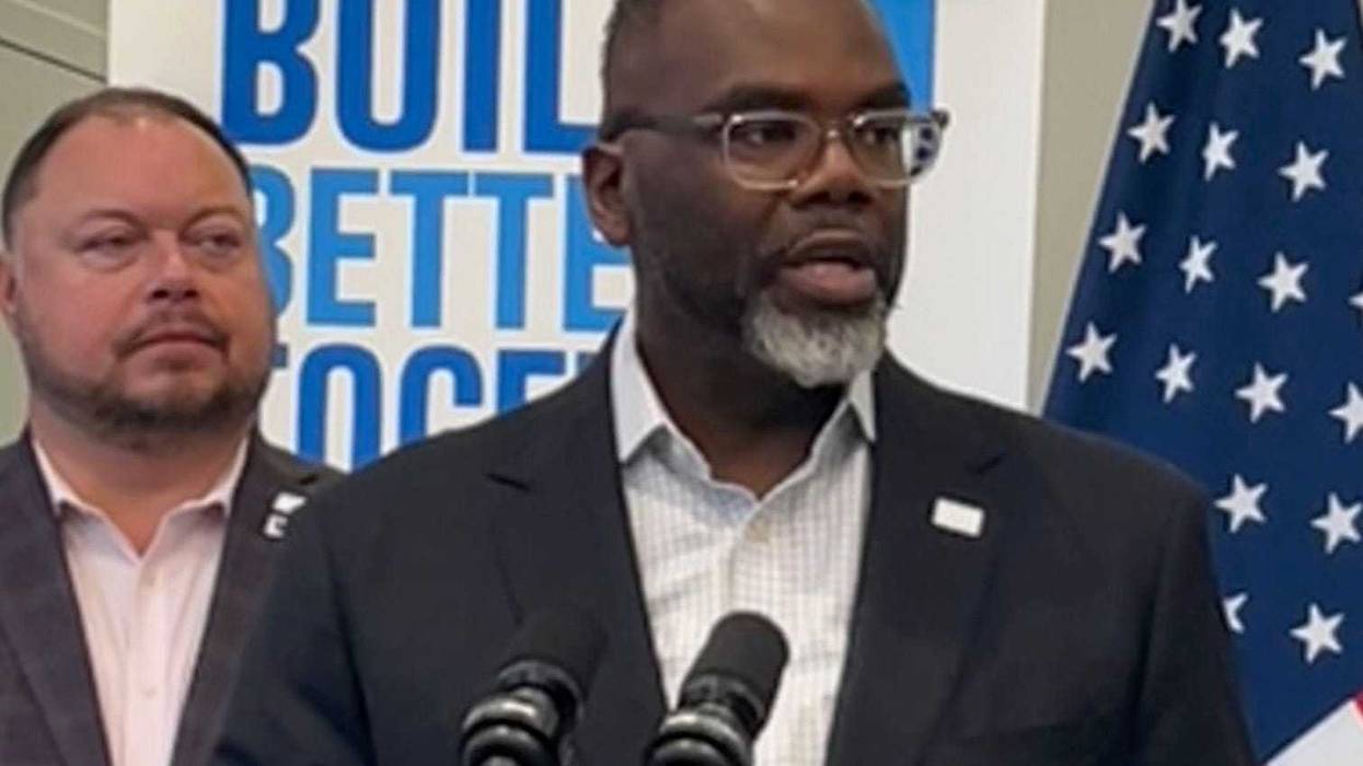 Chicago mayor Brandon Johnson answers questions from reporters during an event in the city's Lakeview neighborhood. Alderman Bennett Lawson (44th Ward) is behind the mayor.