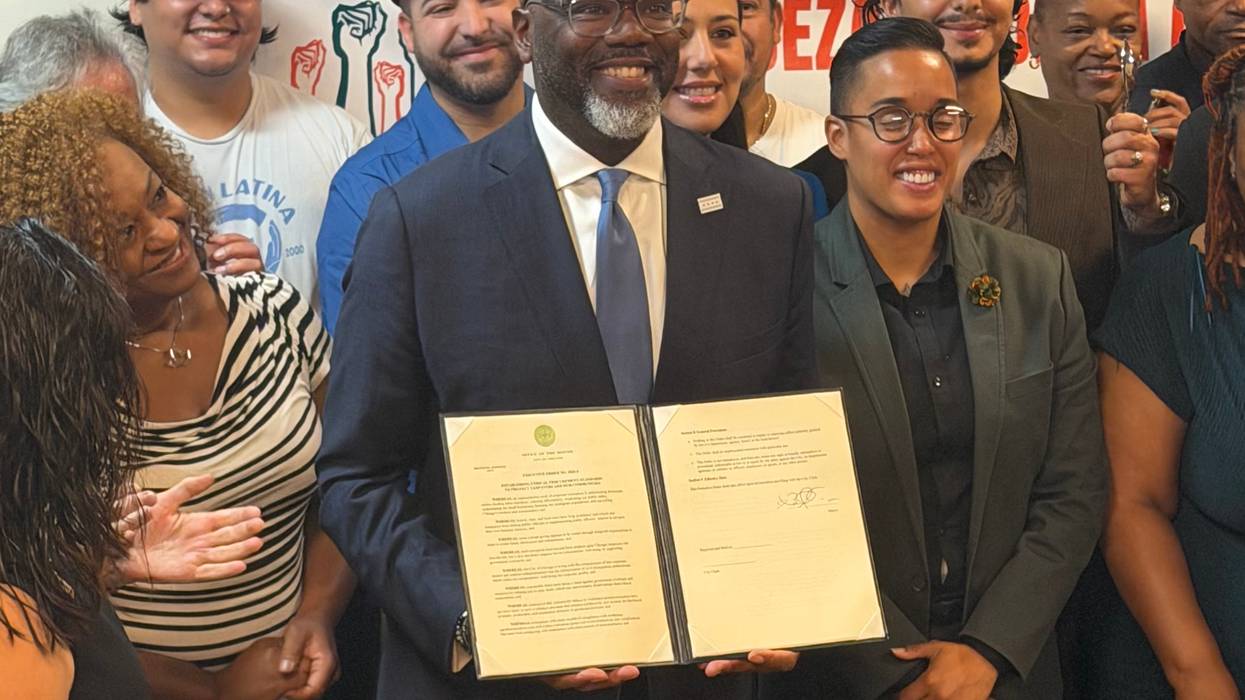 Chicago Mayor Brandon Johnson displays an executive order after a signing ceremony at ARISE Chicago, 1700 W. Hubbard St.