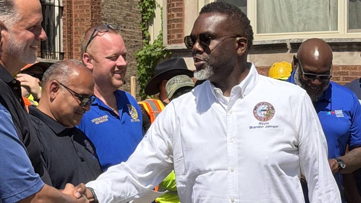 Chicago Mayor Brandon Johnson greets city workers while surveying storm damage on Chicago's South side in June 2026.