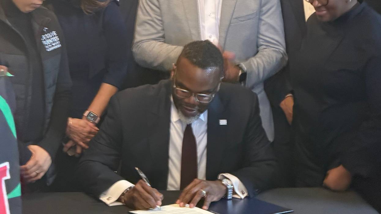 Chicago mayor Brandon Johnson signs a veto declaration at Let's Eat To Live on the city's South side, March 25, 2026.