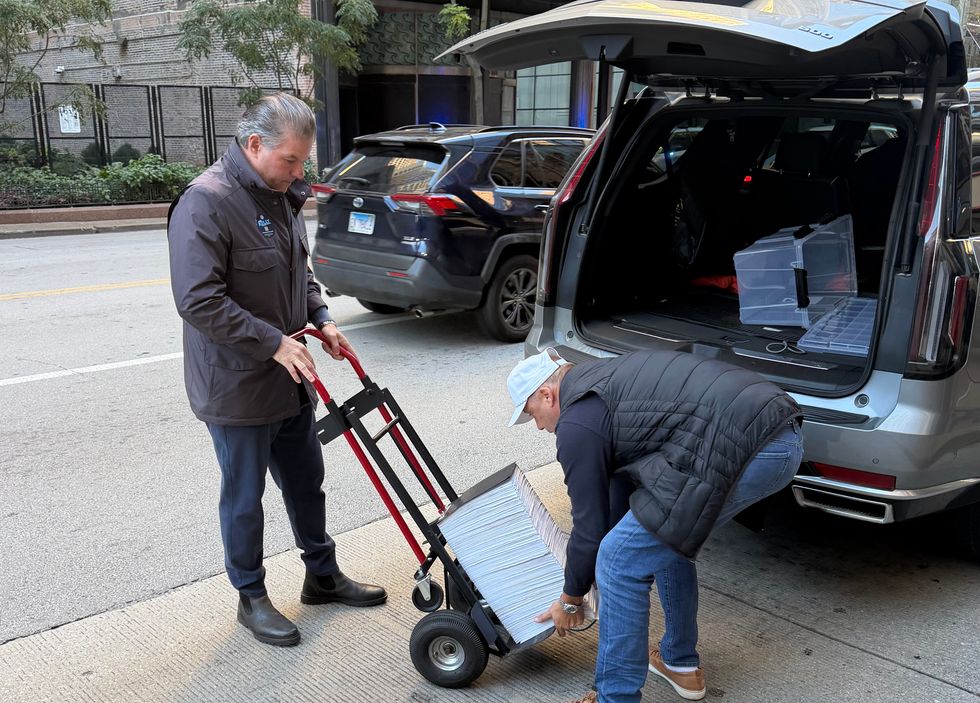 Chicago mayoral candidate John Kelly (left) prepares to file nominating petitions, October 19, 2026.