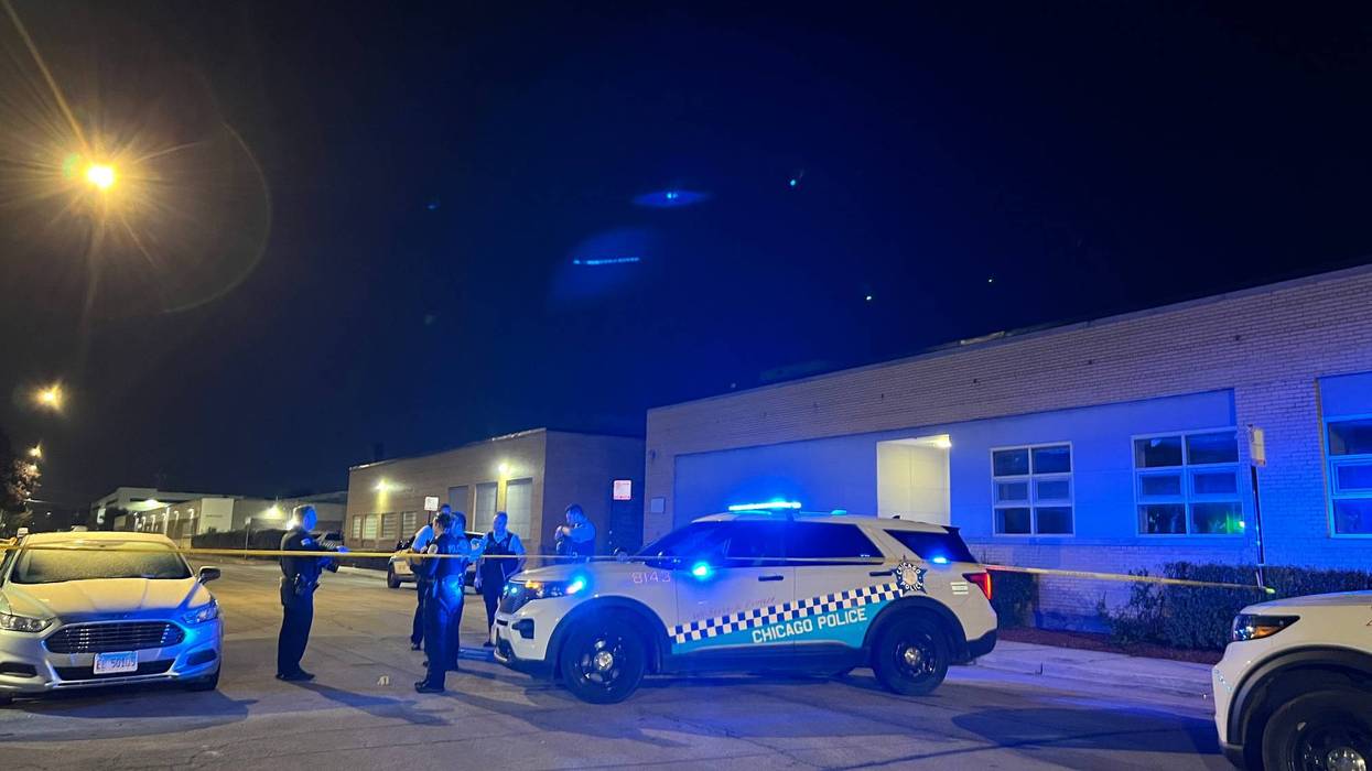 Chicago police officers investigate an early morning shooting outside of Fort Knox Studios in the city's Old Irving Park neighborhood.