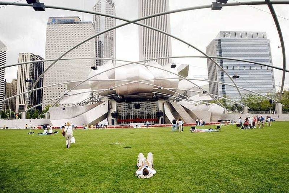 Chicago residents and tourists explore the Pritzker Pavilion designed by famed architect Frank Gehry in the newly opened Millennium park July 16, 2004 in Chicago Illinois.