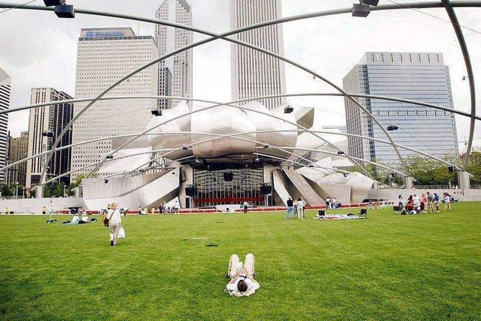 Chicago residents and tourists explore the Pritzker Pavilion designed by famed architect Frank Gehry in the newly opened Millennium park July 16, 2004 in Chicago Illinois.
