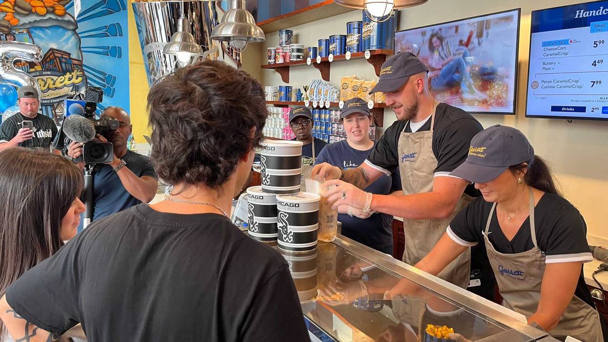 Chicago White Sox pitcher Garrett Crochet and his wife Rachel serve patrons at Garrett's Popcorn Shop on Michigan Avenue in Chicago on Sept. 10, 2024. The pair spent one hour behind the counter as part of the popcorn company's "Scoop for a Cause" campaign, from which a portion of the sales will benefit Chicago White Sox Charities.