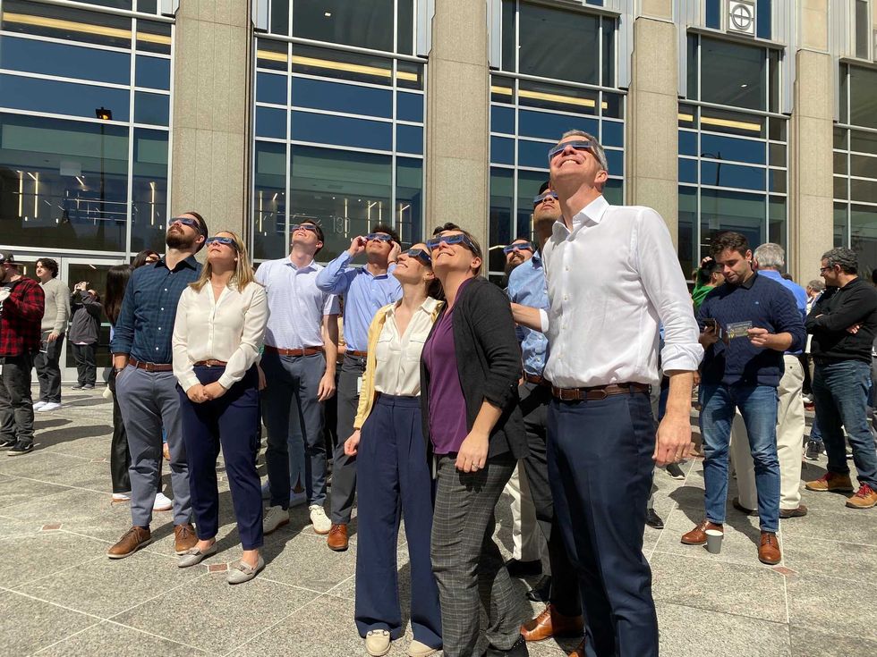 Chicagoans watch the 2024 solar eclipse downtown on Monday.