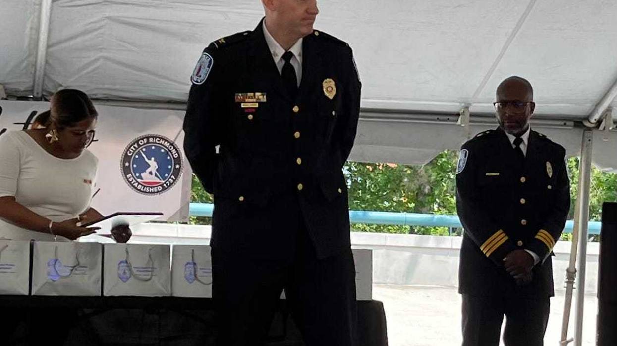 Chief Edwards, on stage, hands behind his back