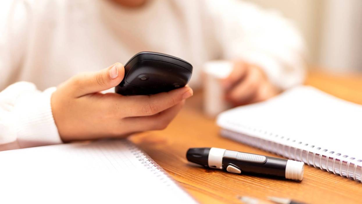 Child checks their blood sugar.