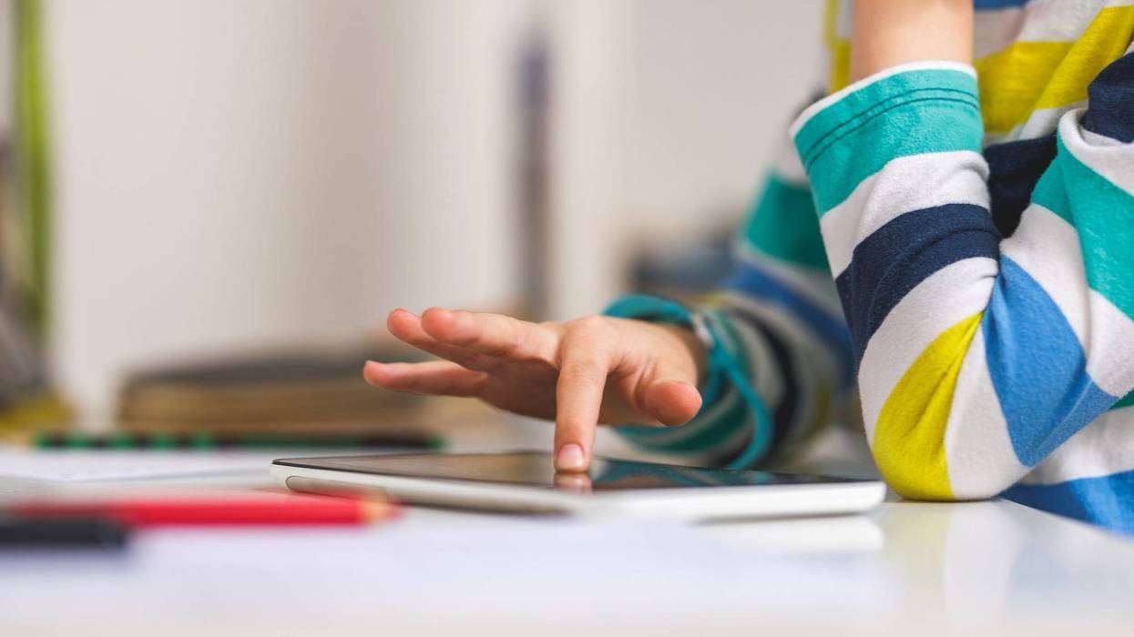 Child hand pointing on Digital tablet
